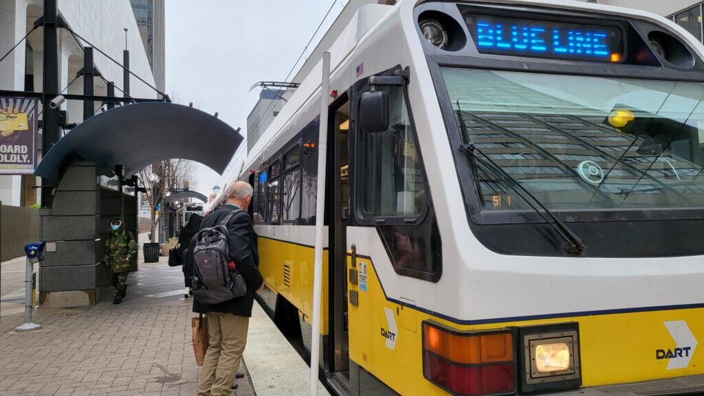 Man getting on a street car in Dallas, Texas